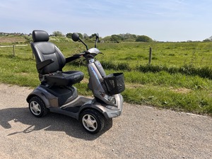 MOBILITY SCOOTER in front of a field